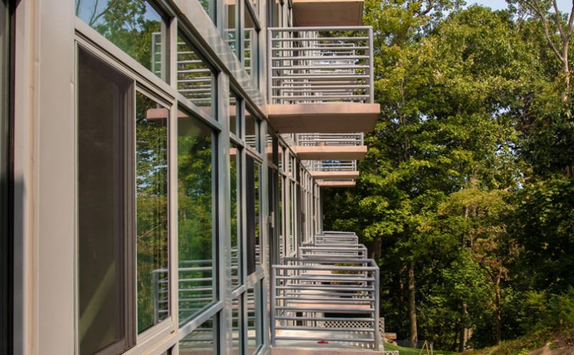private balconies overlook wooded areas surrounding Glasshouse 250